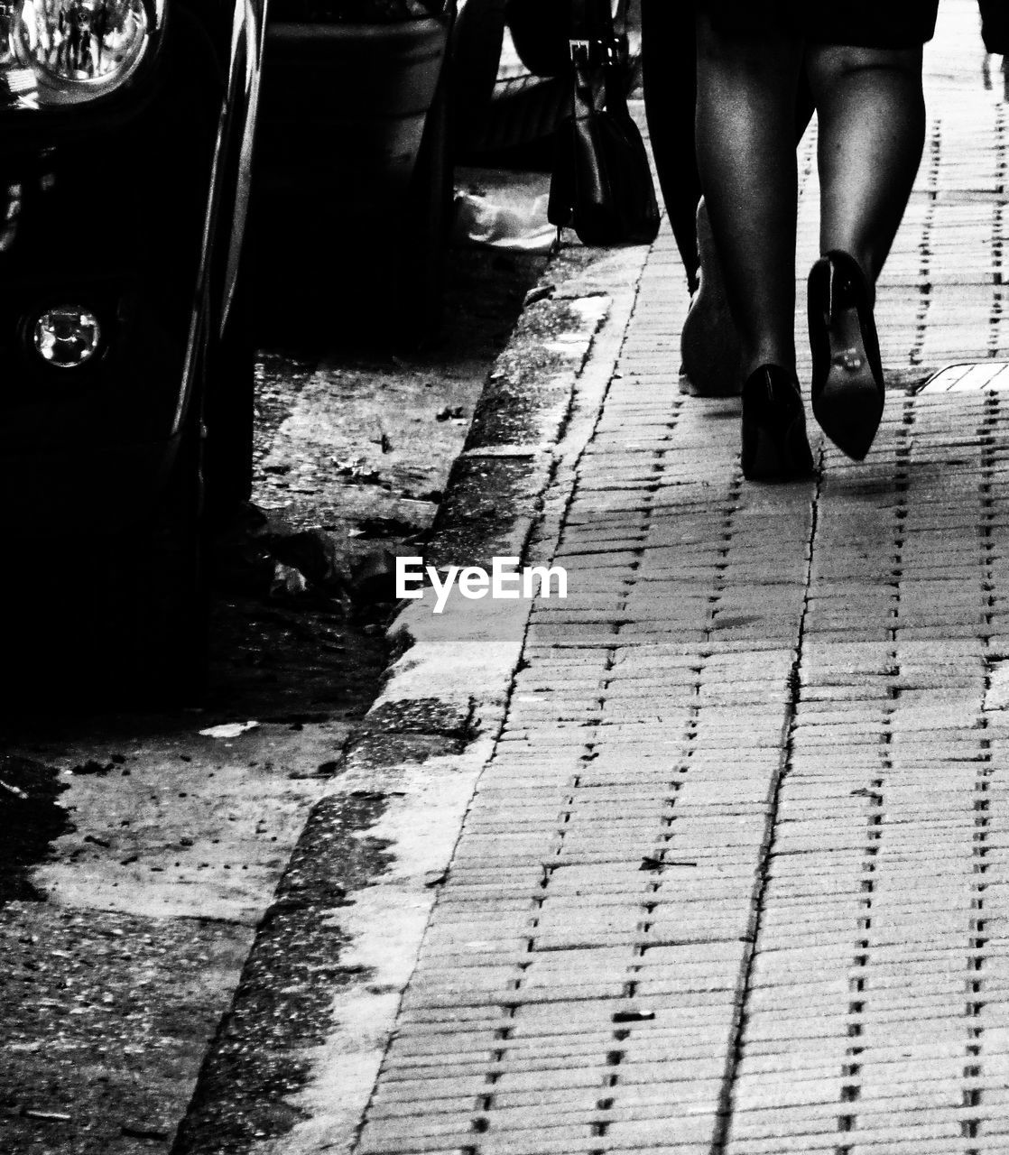 LOW SECTION OF WOMAN STANDING ON STREET