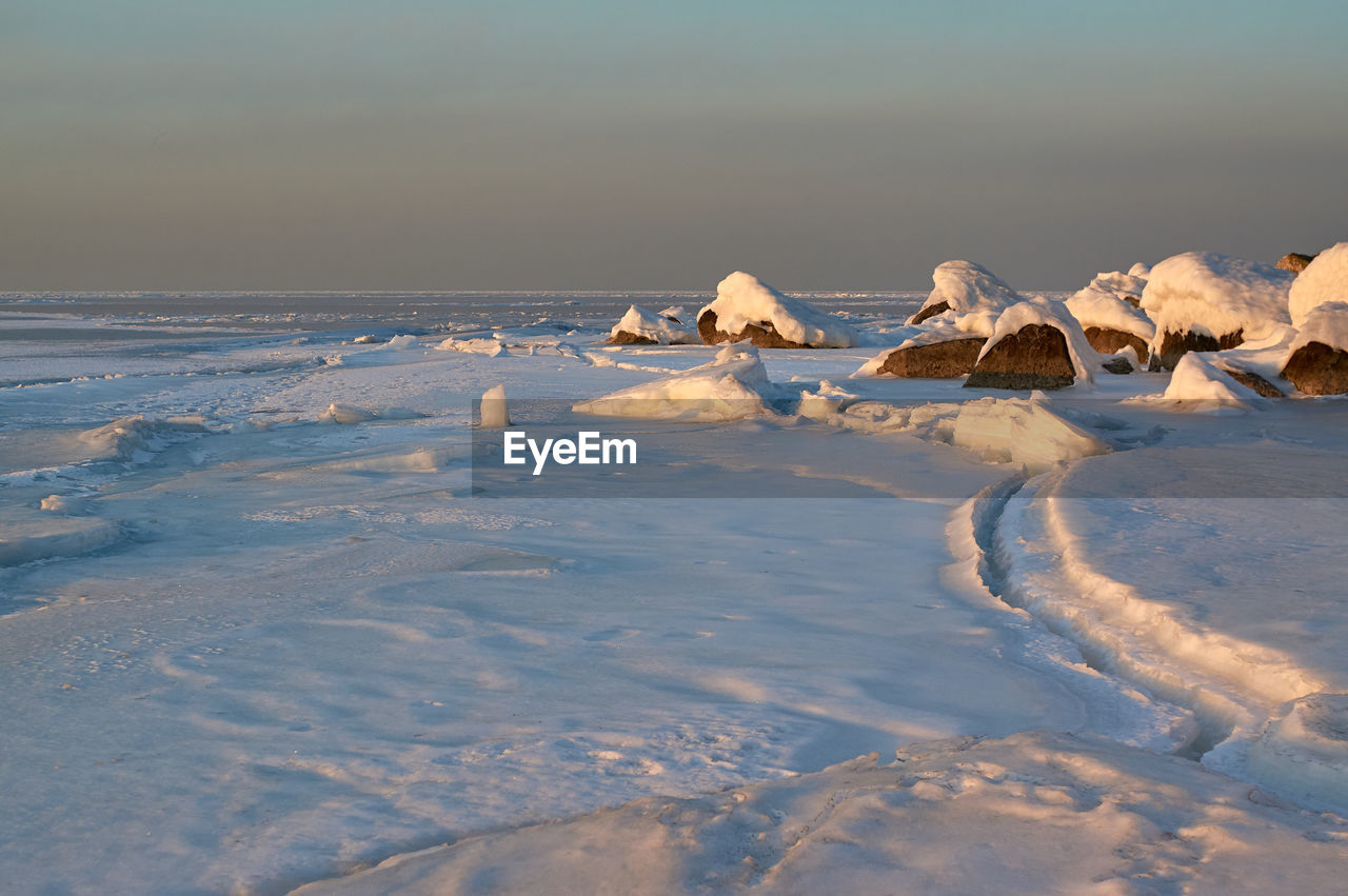 Scenic view of sea against sky during winter