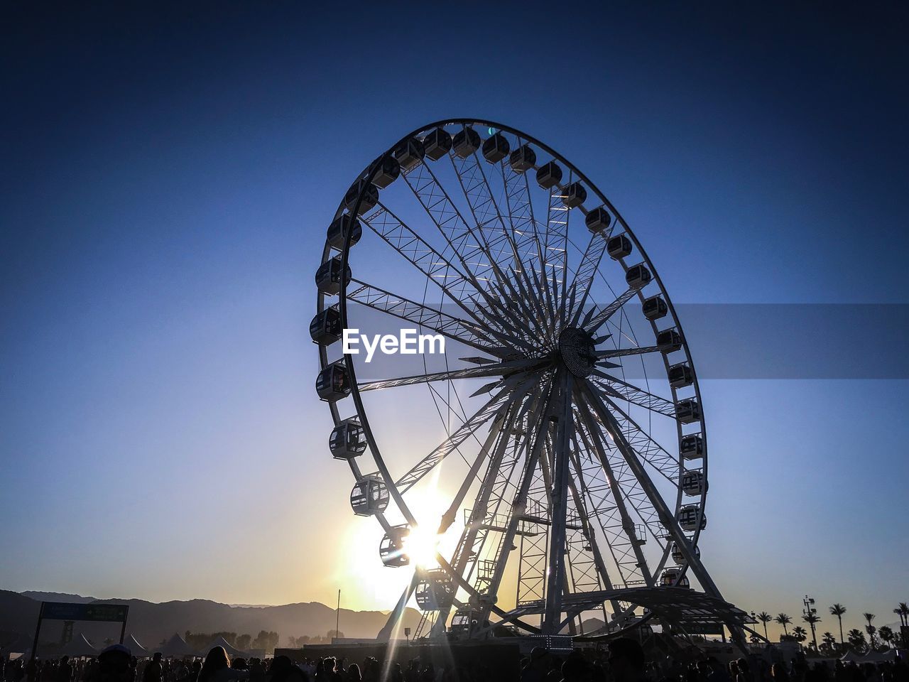 LOW ANGLE VIEW OF FERRIS WHEEL AGAINST CLEAR BLUE SKY