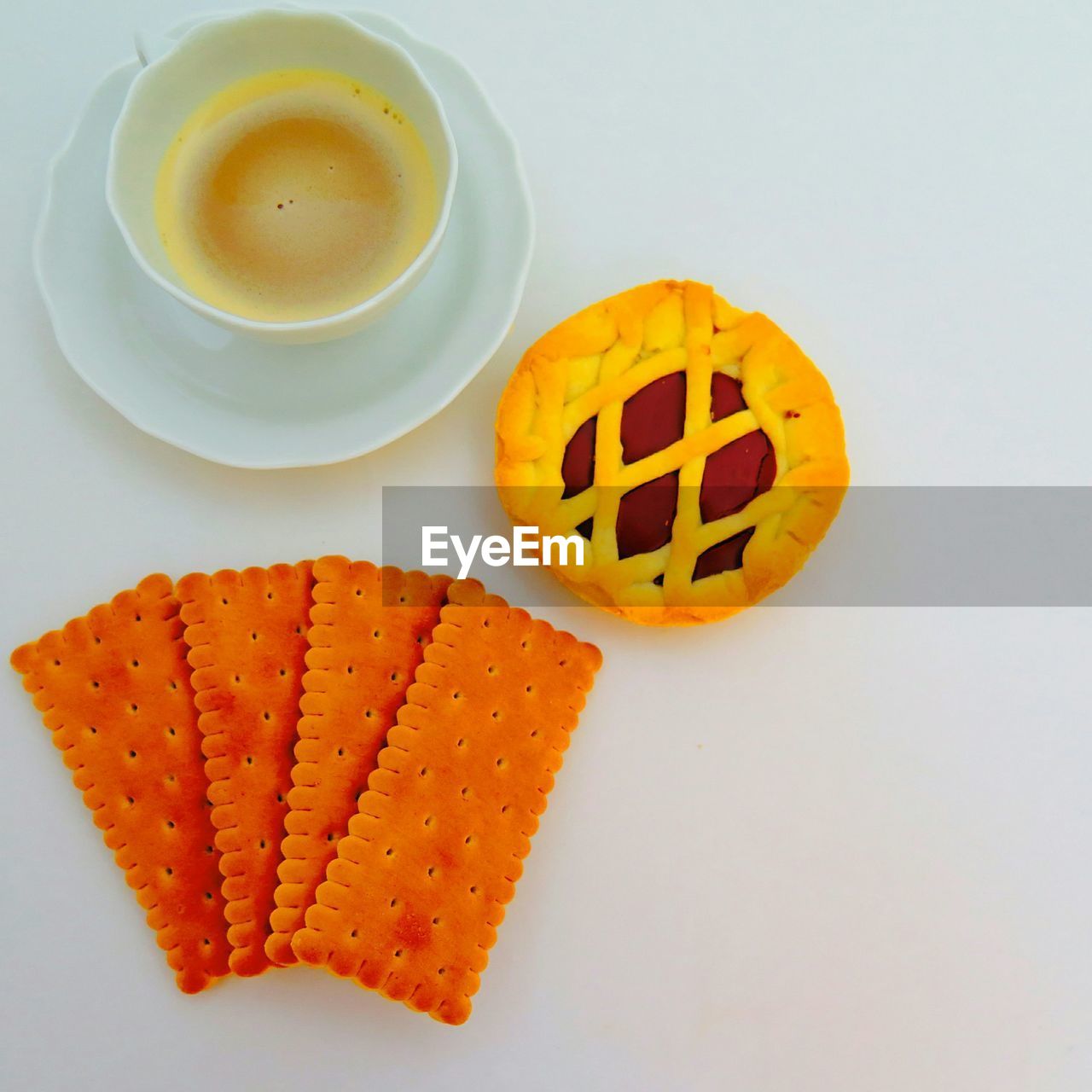 High angle view of cracker biscuit with pie by coffee cup on table