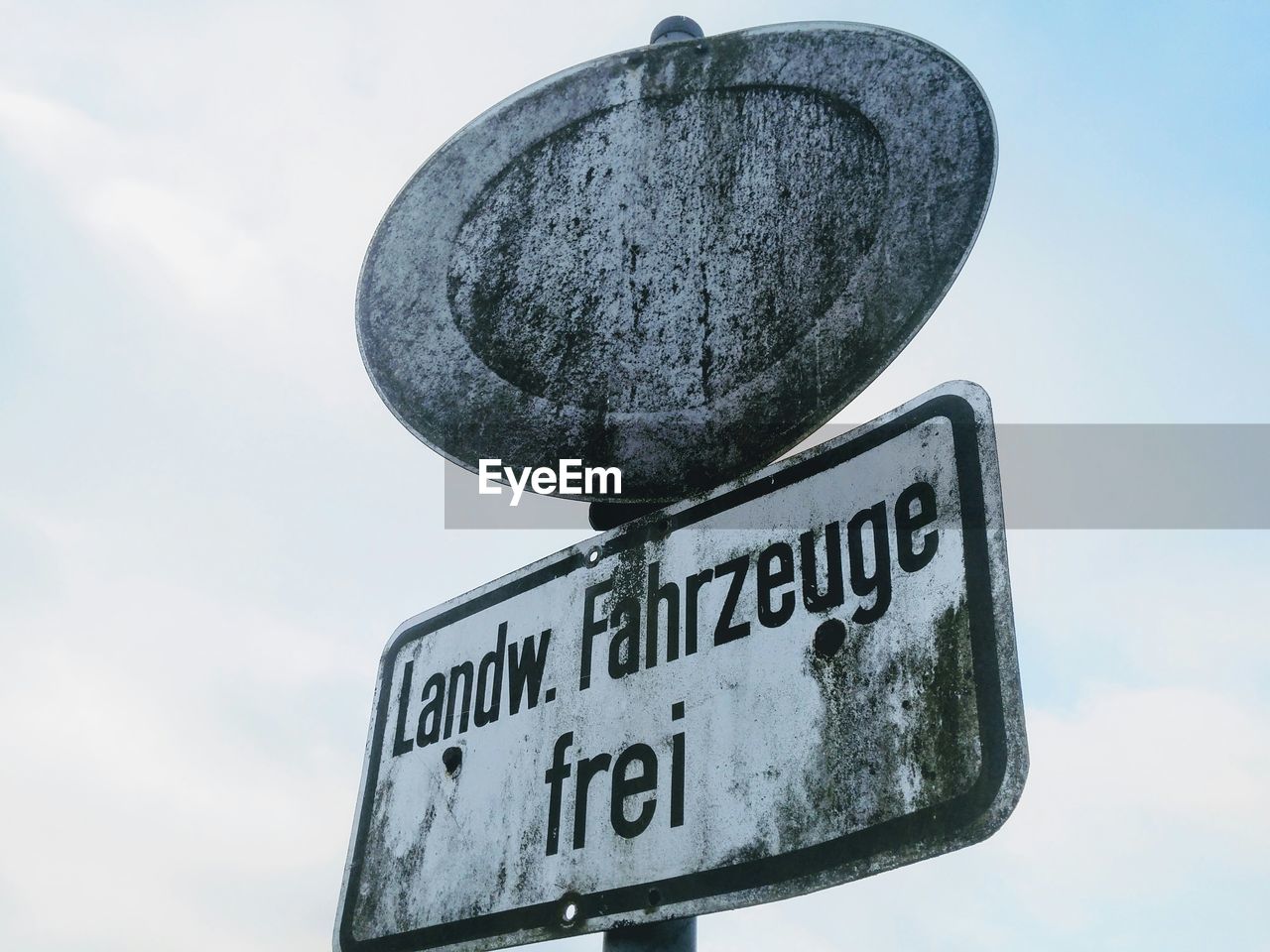 Low angle view of signboard against sky