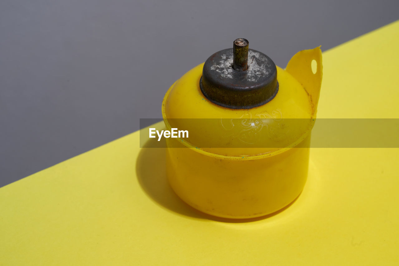 Yellow oil lamp on the yellow background