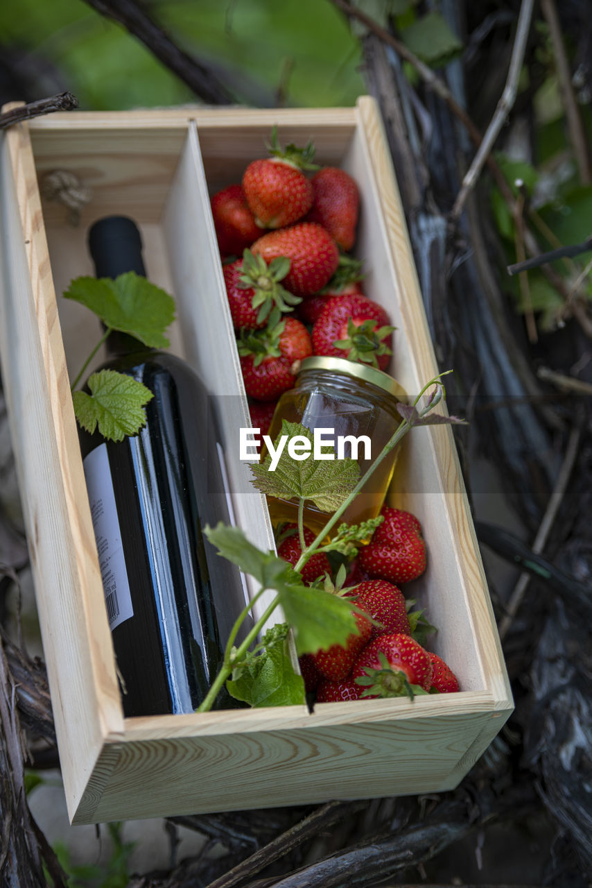 food, healthy eating, food and drink, berry, strawberry, fruit, container, wellbeing, freshness, box, basket, produce, plant, crate, no people, nature, wood, agriculture, high angle view, organic, harvesting, red, flower, leaf, outdoors, vegetable, plant part, day, abundance, large group of objects