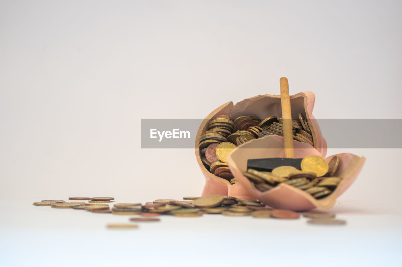 studio shot, indoors, one person, finance, adult, copy space, business, currency, white background, wood, figurine, toy, paper currency, art, full length