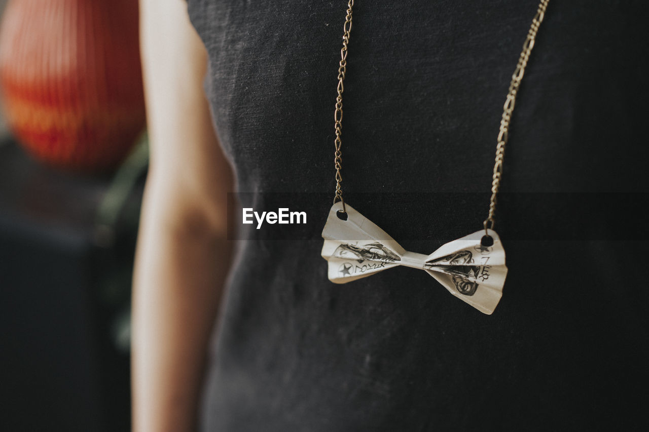 Midsection of woman wearing necklace
