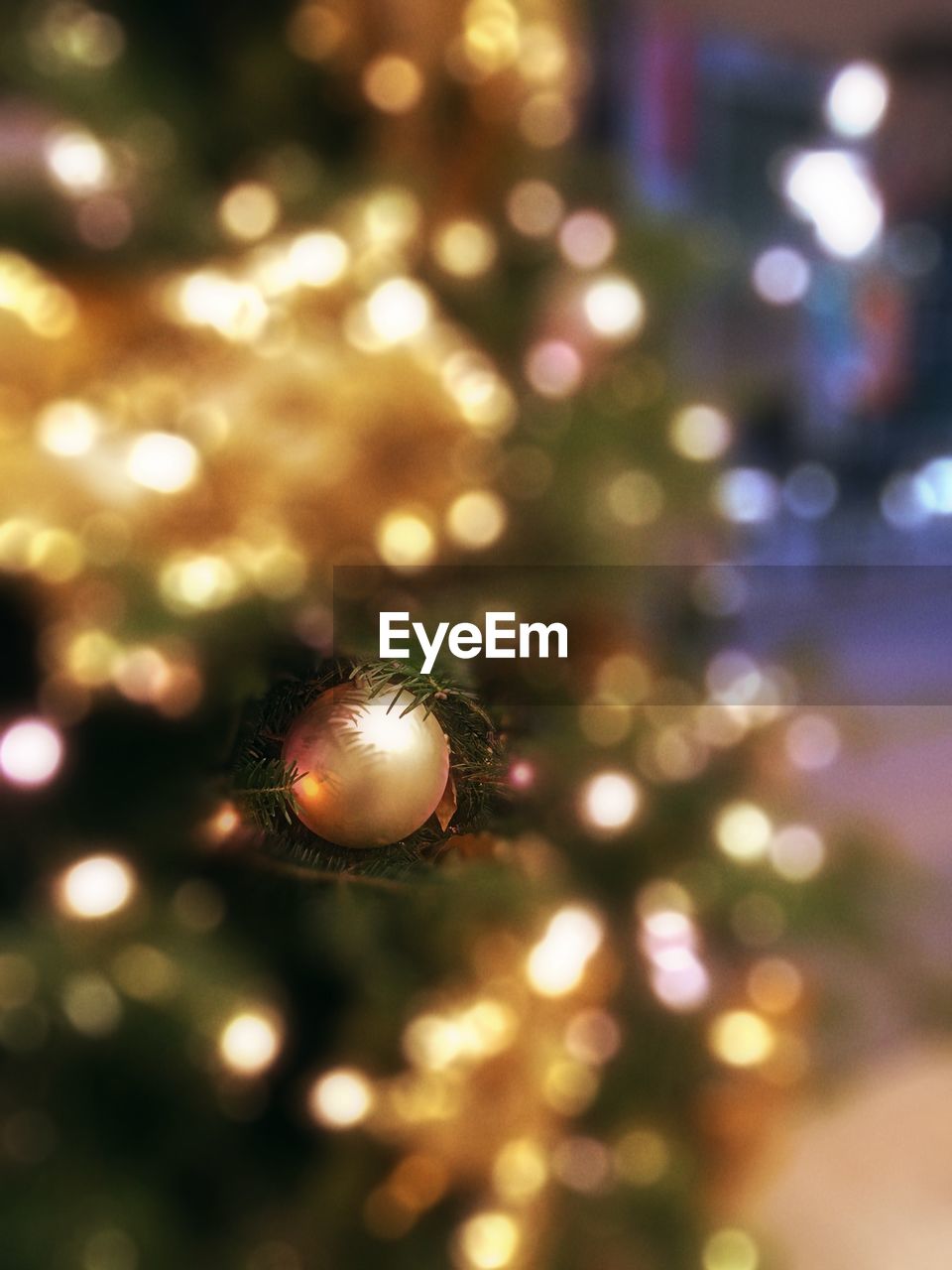 Close-up of bauble on illuminated christmas tree