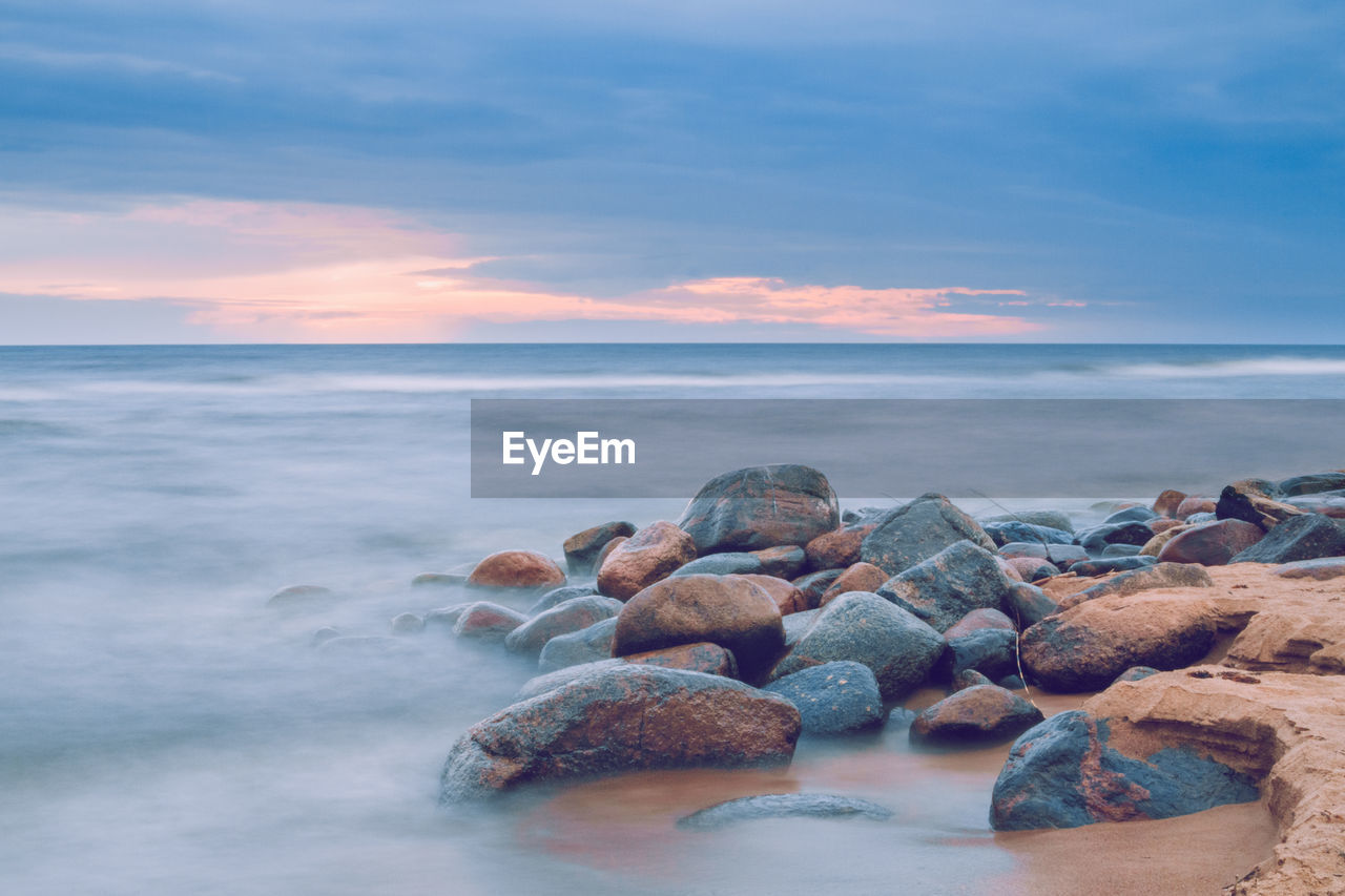 Scenic view of sea against sky at sunset