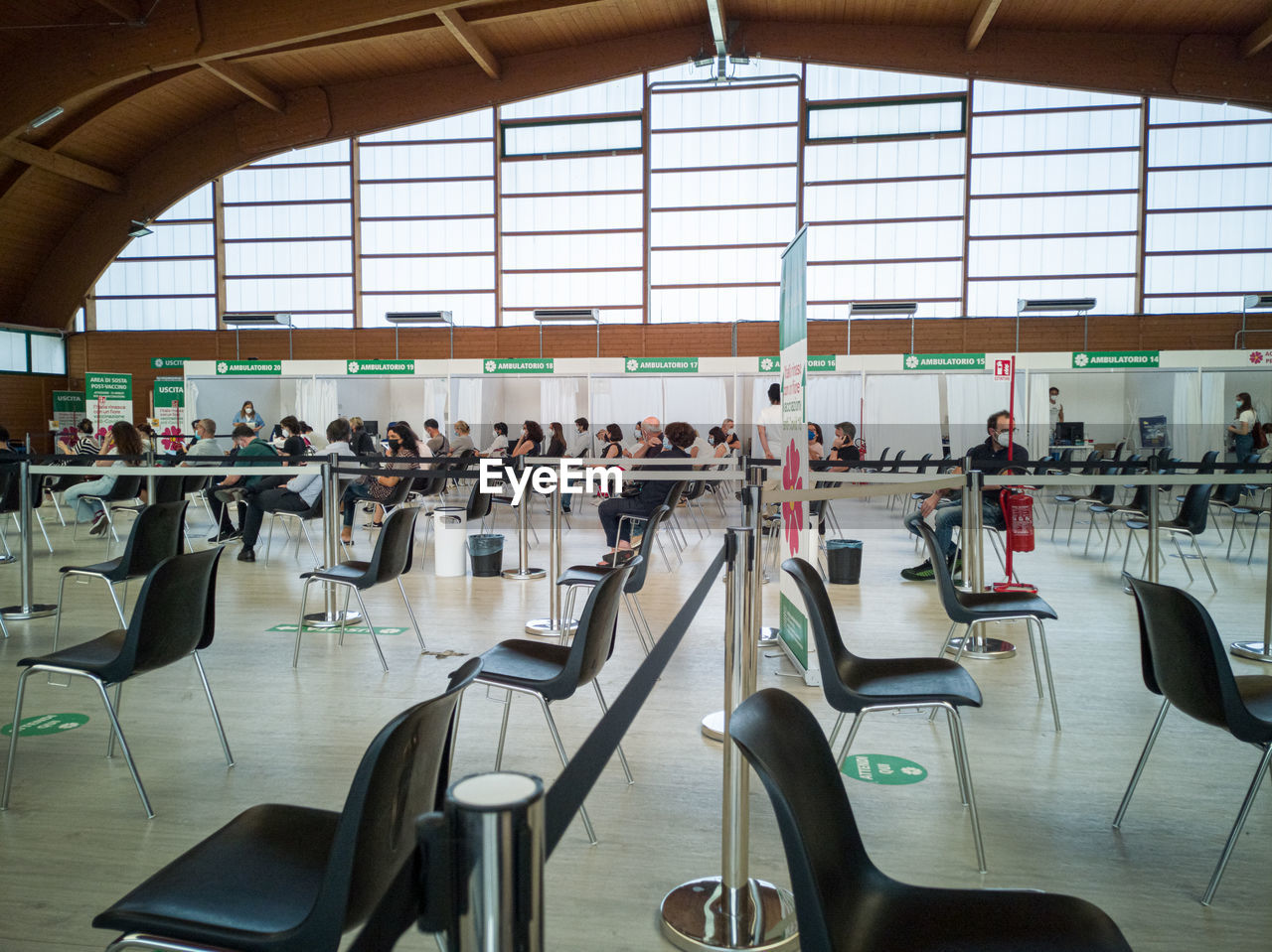 indoors, seat, travel, chair, airport, sport venue, group of people, airport departure area, room, large group of people, crowd, architecture, window, transportation, table, business, in a row, adult, day, travel destinations