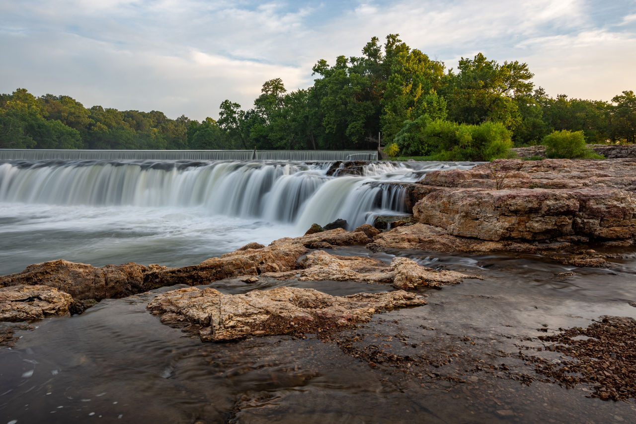 water, waterfall, body of water, environment, scenics - nature, river, nature, tree, beauty in nature, environmental conservation, sky, motion, travel destinations, landscape, travel, land, plant, tourism, flowing water, water feature, cloud, flowing, social issues, long exposure, coast, shore, tropical climate, forest, rock, no people, outdoors, water resources, rapid, holiday, trip, vacation, watercourse, architecture, stream