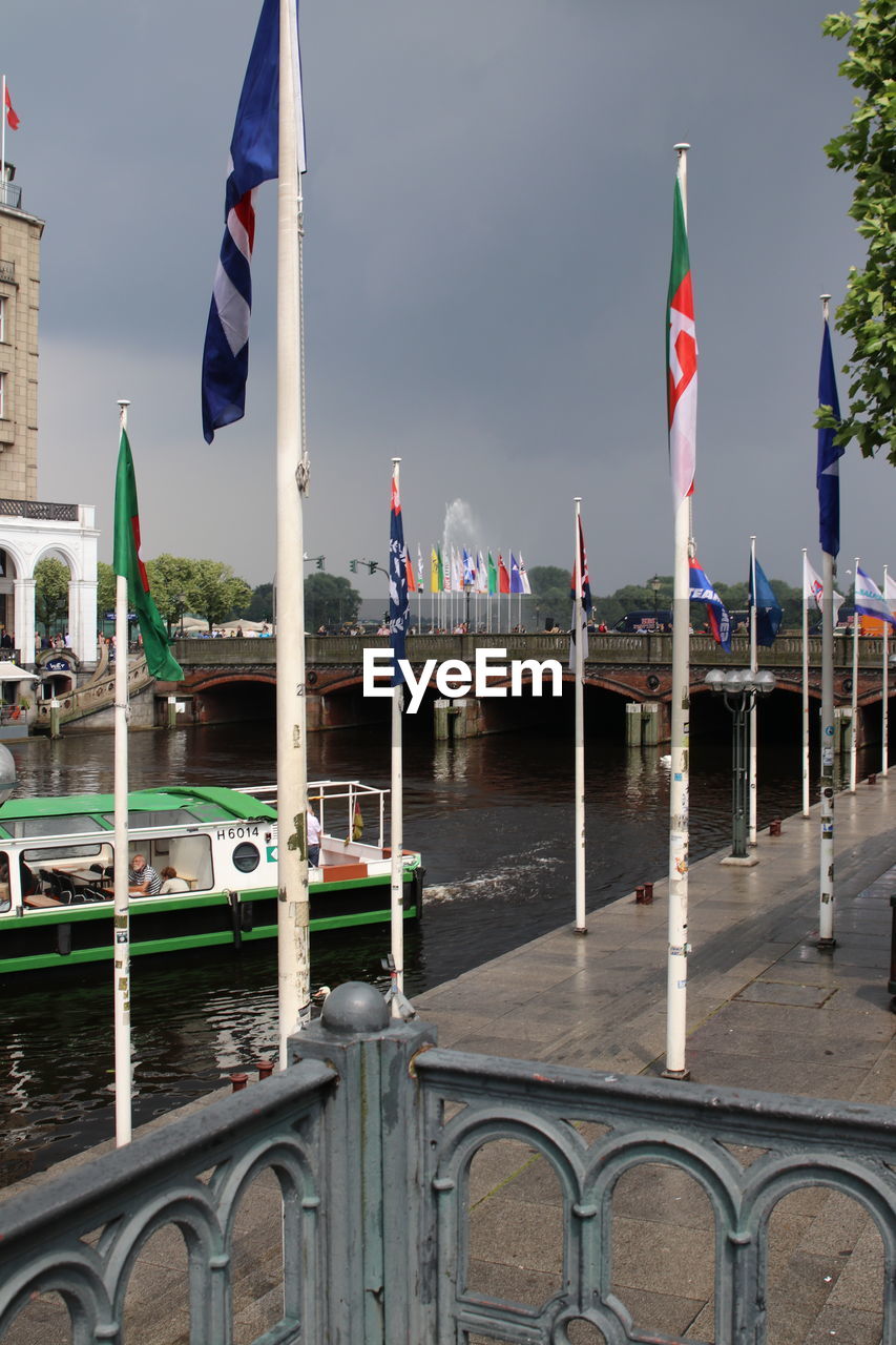 LOW ANGLE VIEW OF FLAG AGAINST BUILT STRUCTURES