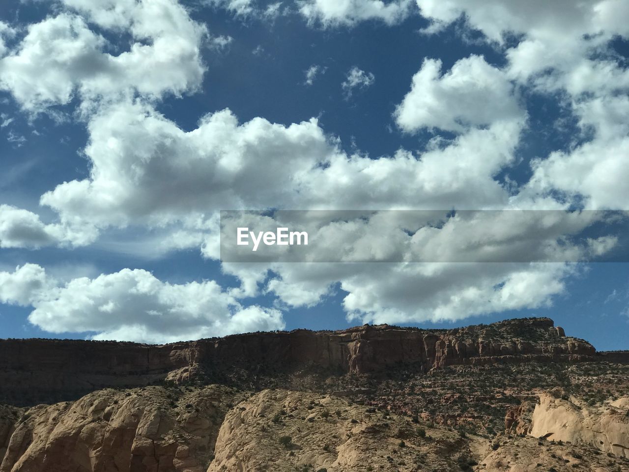 Low angle view of land against cloudy sky