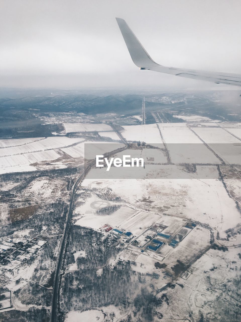 AERIAL VIEW OF LANDSCAPE AGAINST SKY DURING WINTER