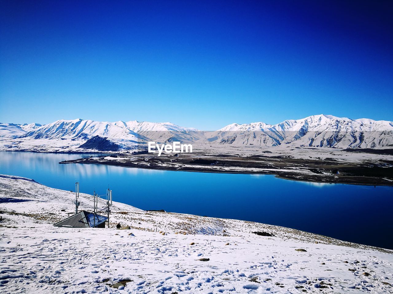 Scenic view of snow covered mountain against clear sky