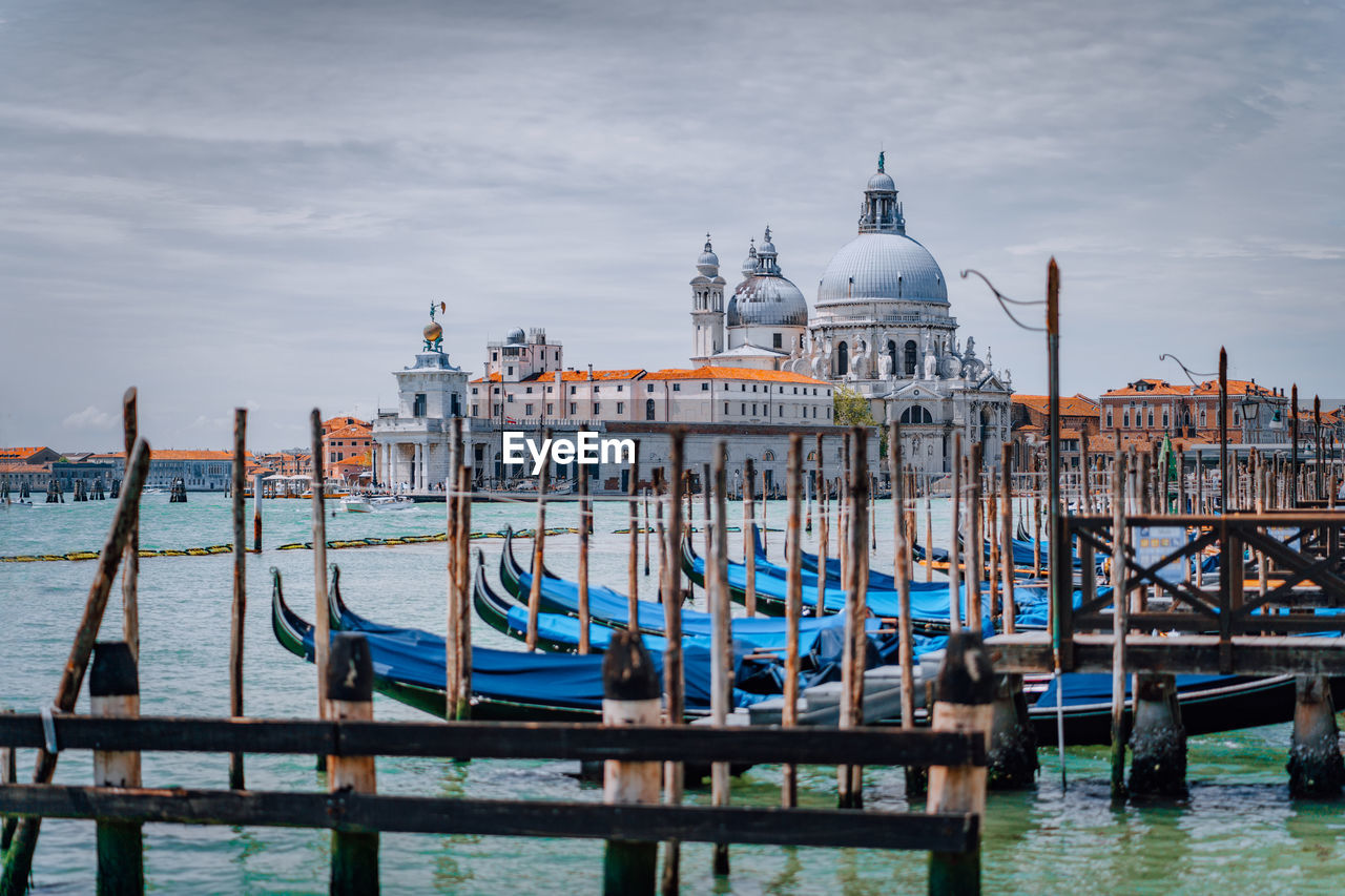 Boats moored in canal against santa maria della salute