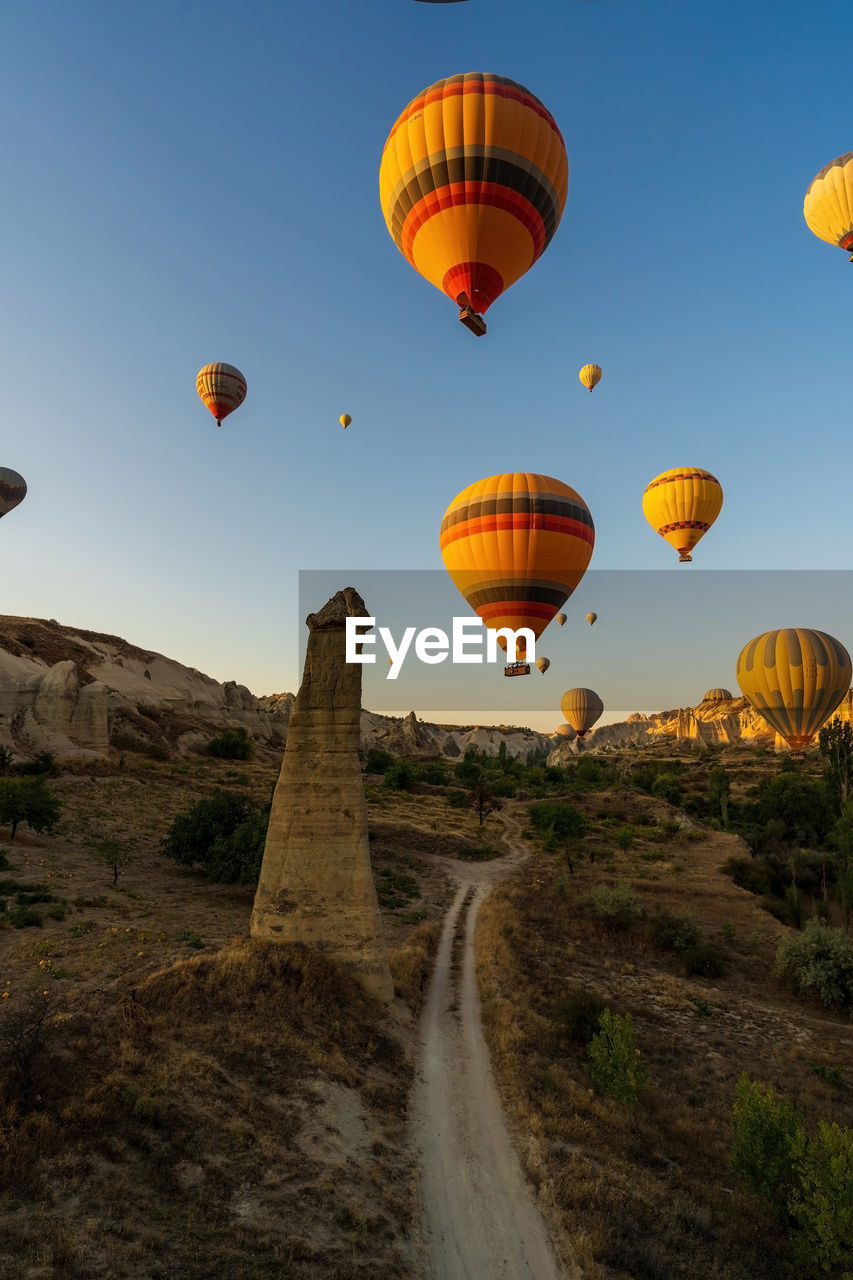 Colorful hot air balloon flying early morning in cappadocia, rock formation due to volcanic activity