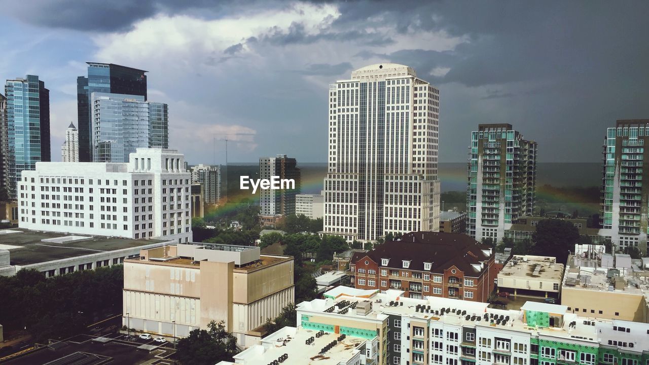 Rainbow with buildings against the sky