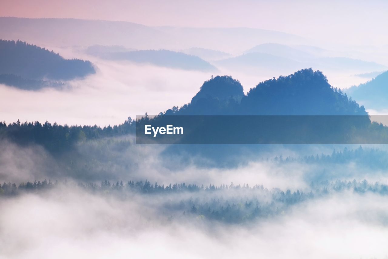 SCENIC VIEW OF MOUNTAINS AGAINST SKY AT SUNSET