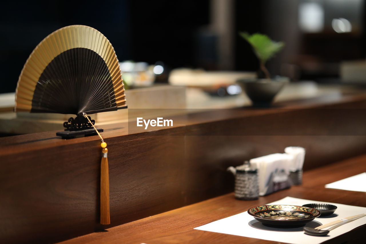 CLOSE-UP OF ELECTRIC LIGHT BULB ON TABLE