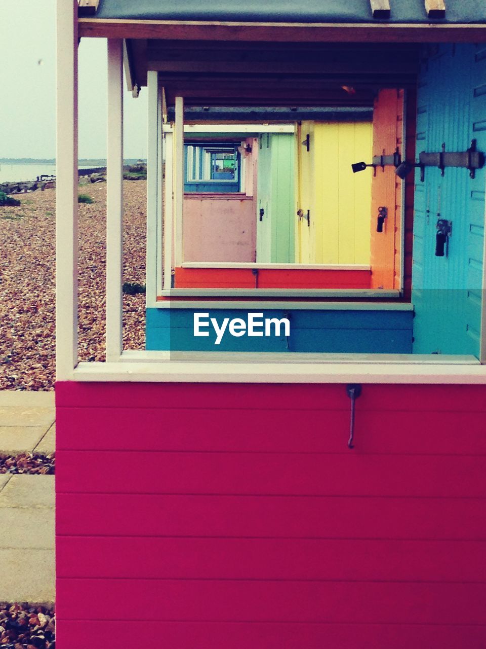 Multi colored beach huts on shore