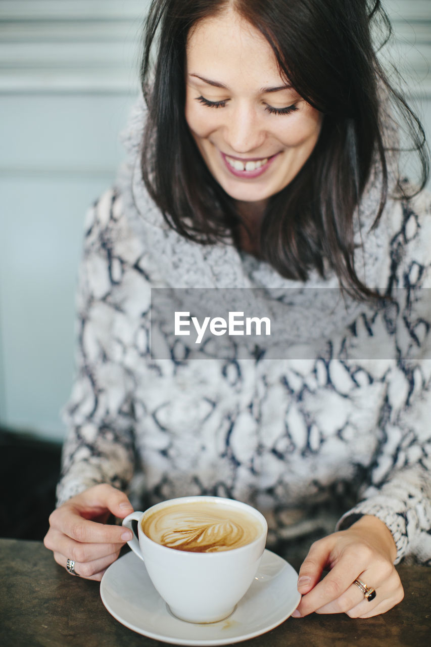 Young woman with cup of coffee