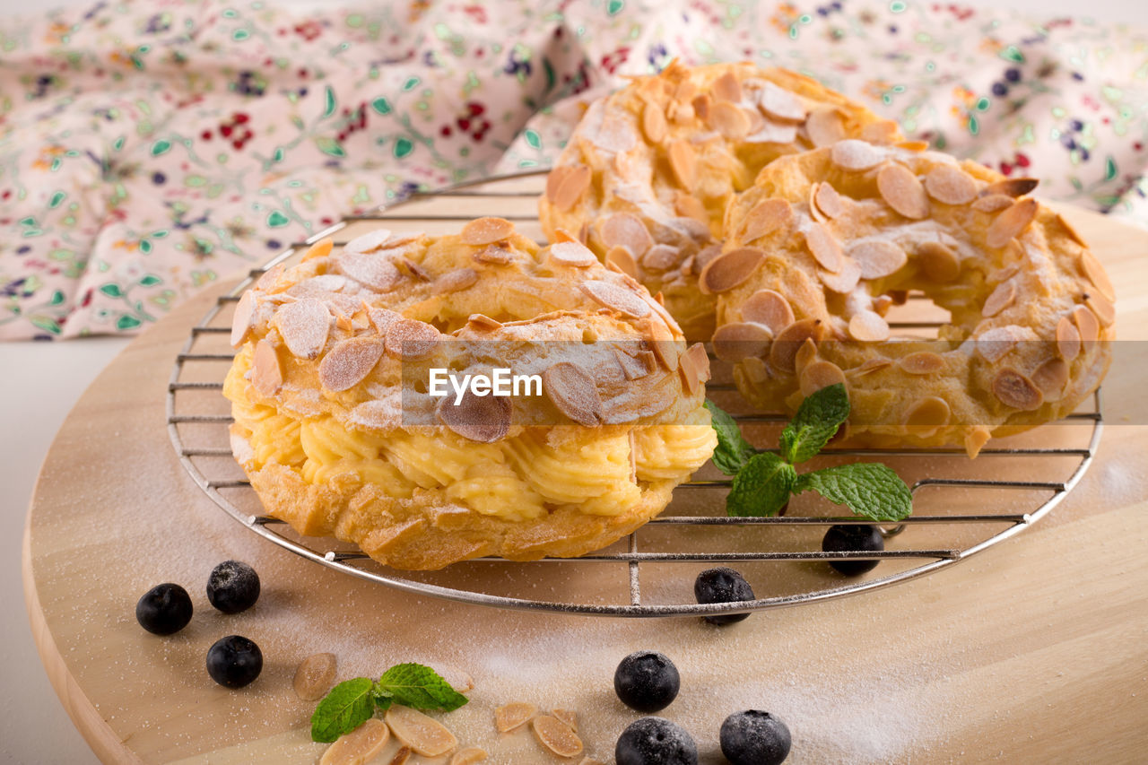 Almond donuts on cooking rack by blueberries