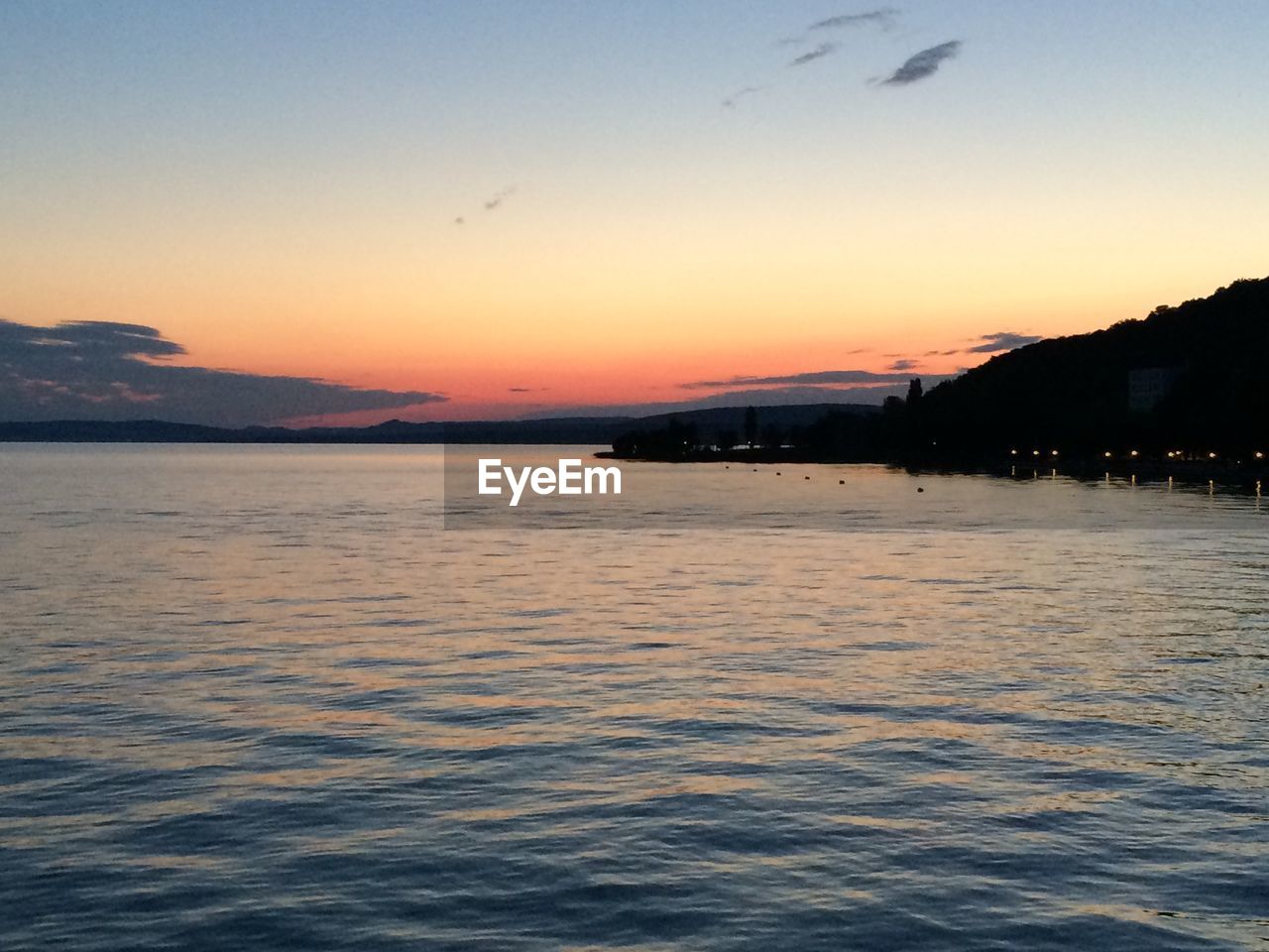 Scenic view of lake balaton against sunset sky