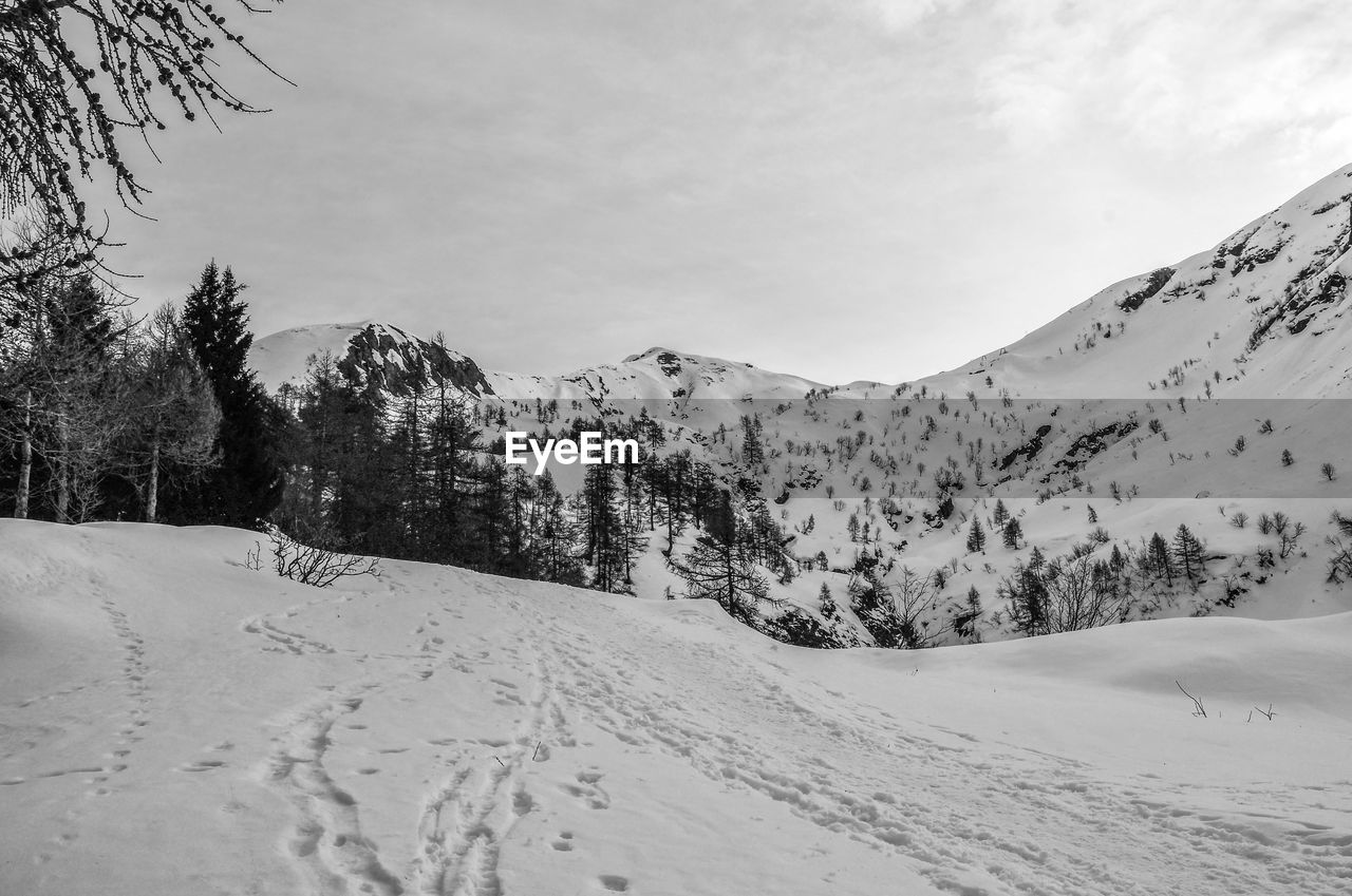 Scenic view of snow covered mountains against sky