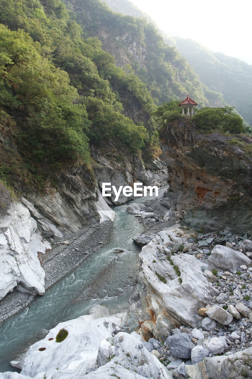 High angle view of river flowing by mountains