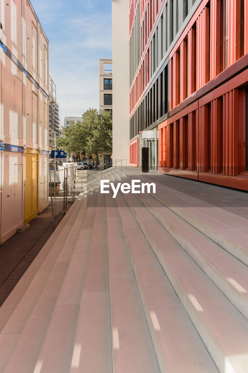 STREET AMIDST BUILDINGS AGAINST SKY