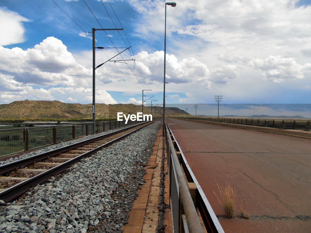 Surface level of railway tracks along empty road