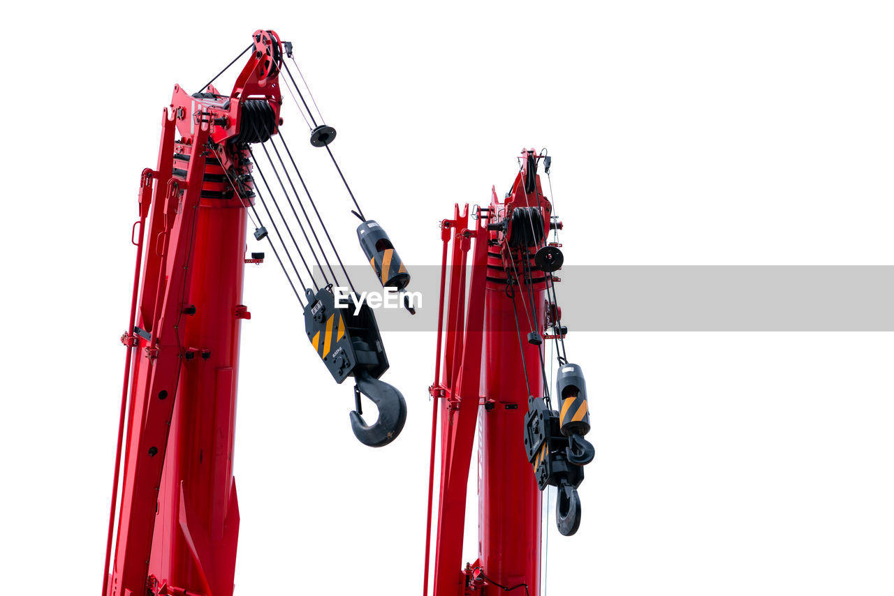 Construction crane for heavy lifting isolated on white. construction industry. red crane with hook.