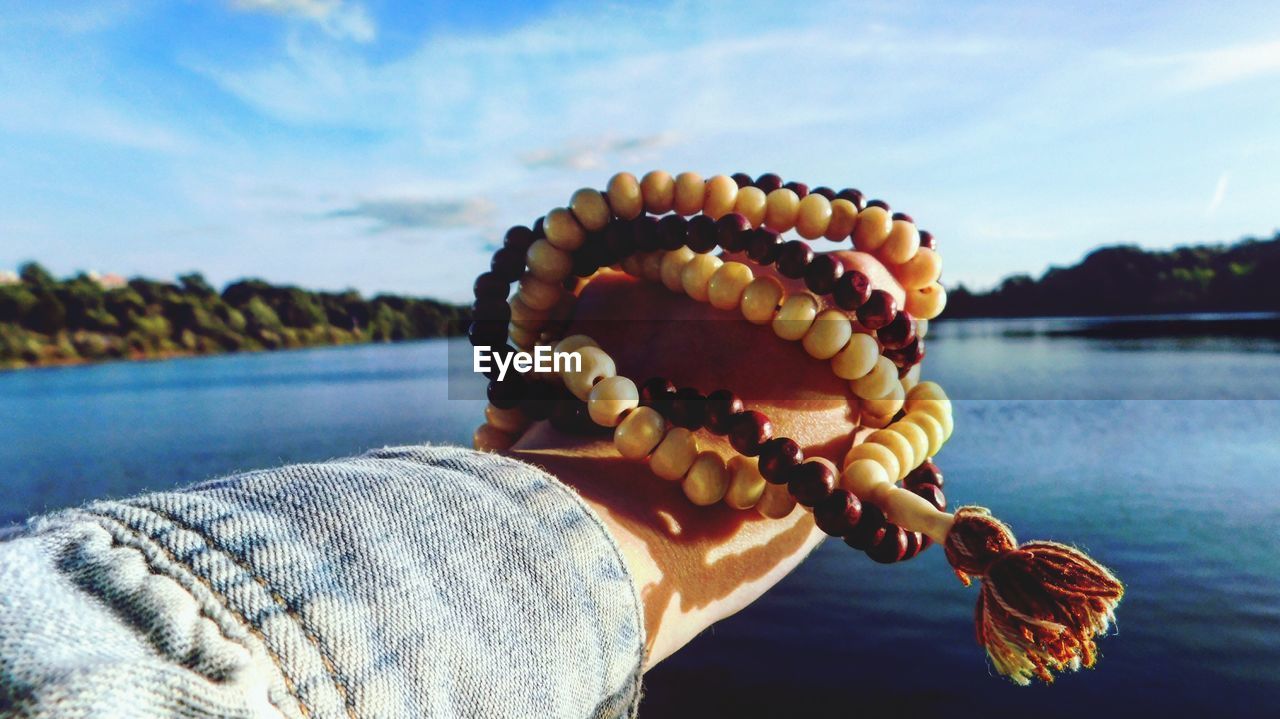 Persons hand holding prayer beads