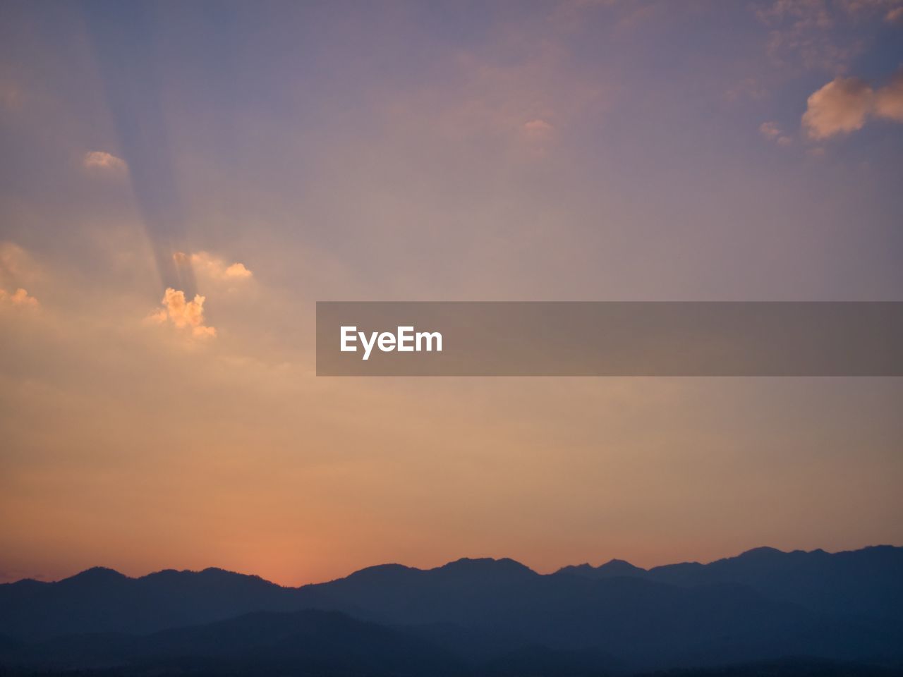 Scenic view of silhouette mountains against sky during sunset