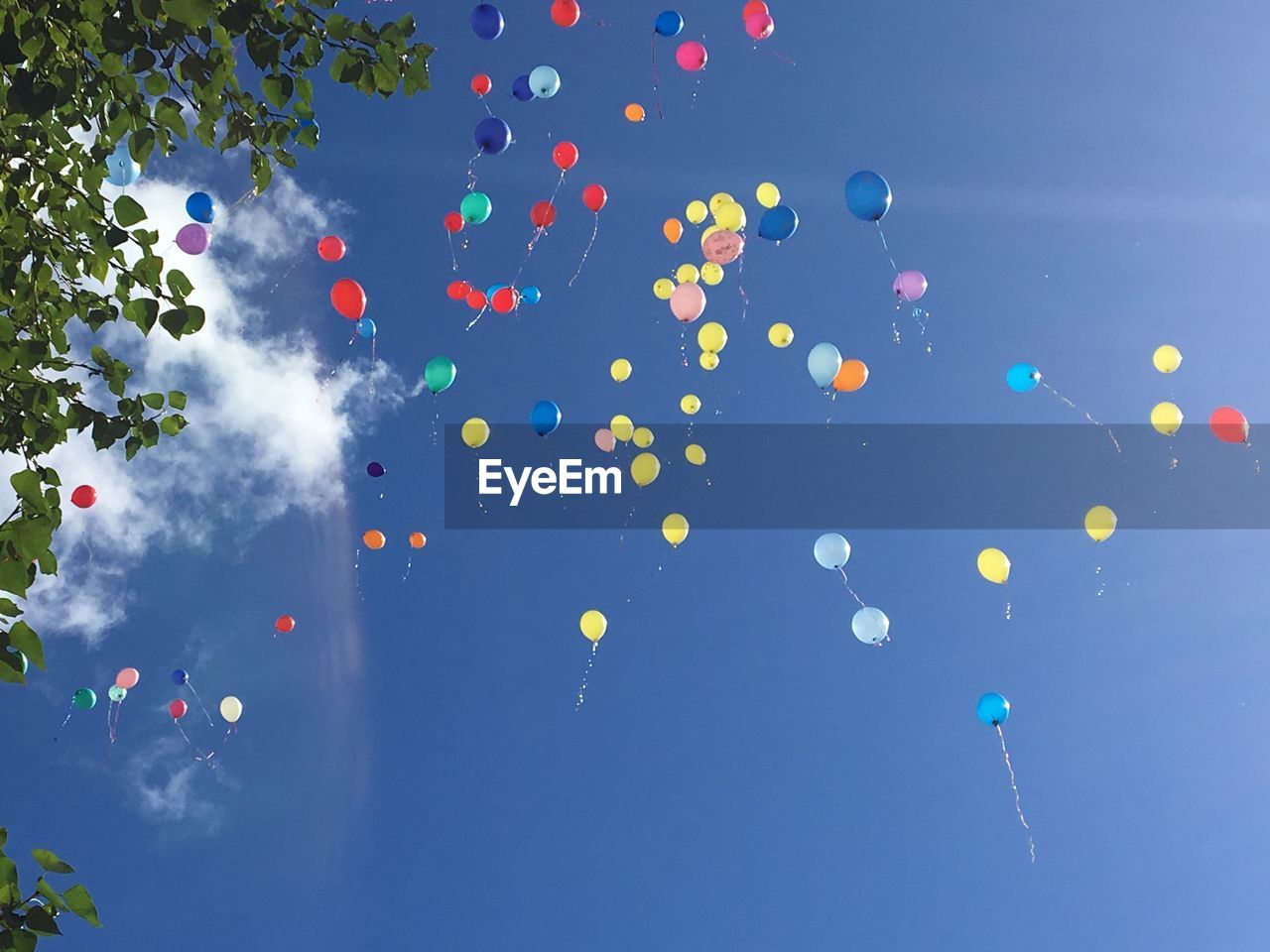 Low angle view of balloons in blue sky