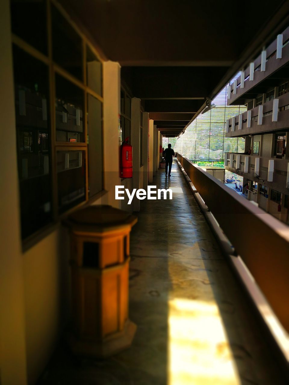 WOMAN WALKING IN CORRIDOR