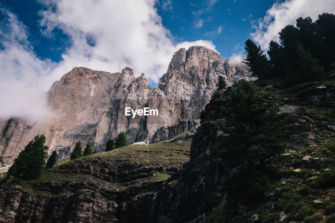 Low angle view of rocky mountains against sky