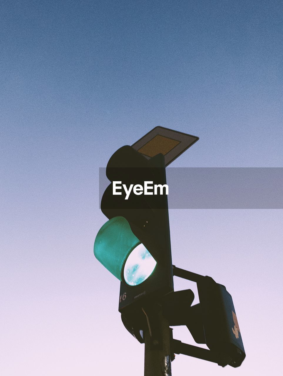 Low angle view of road signal against clear sky