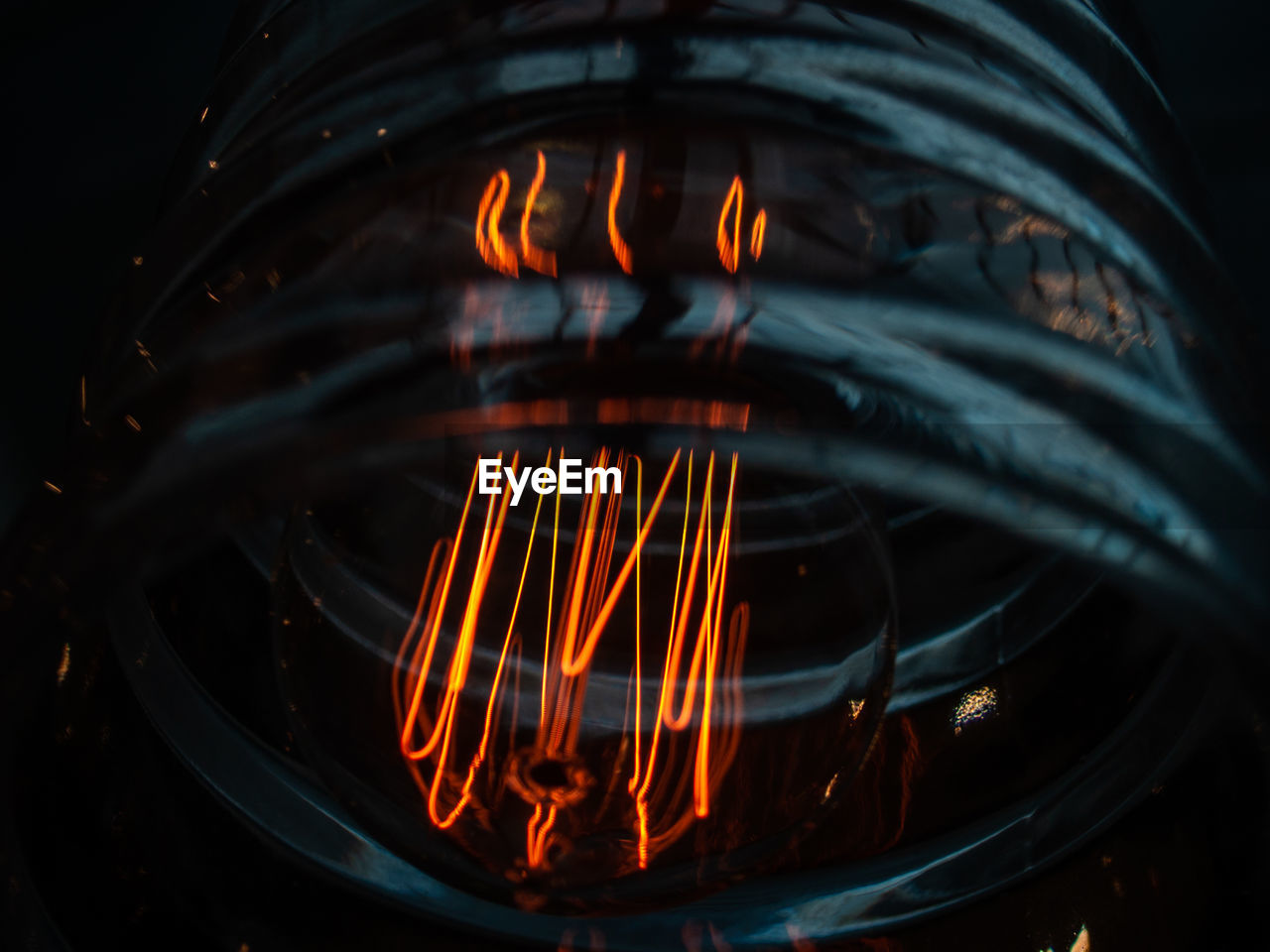 CLOSE-UP OF ILLUMINATED FIRE BURNING IN KITCHEN