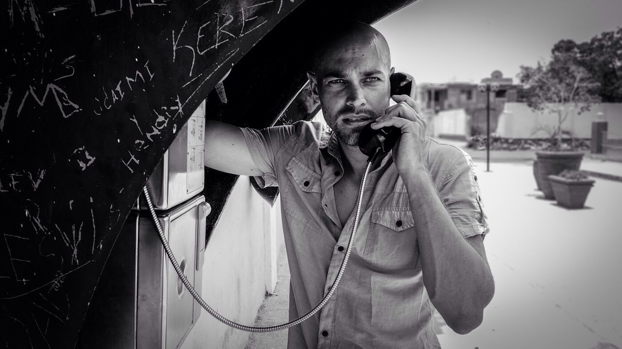 Man making call at telephone booth