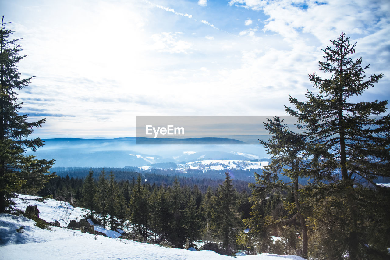 Scenic view of snow covered mountains against sky