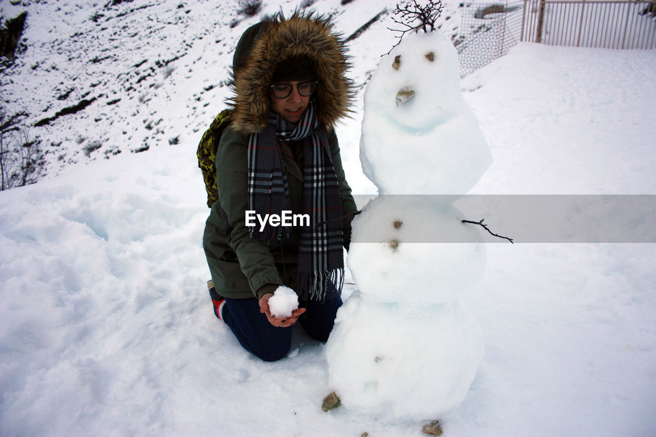 WOMAN WITH SNOW COVERED FACE WITH ARMS