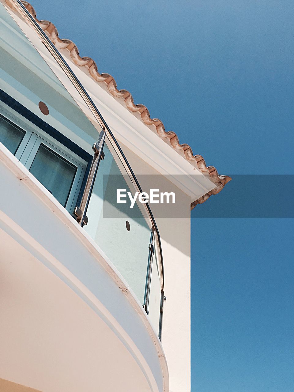 Low angle view of building against clear blue sky