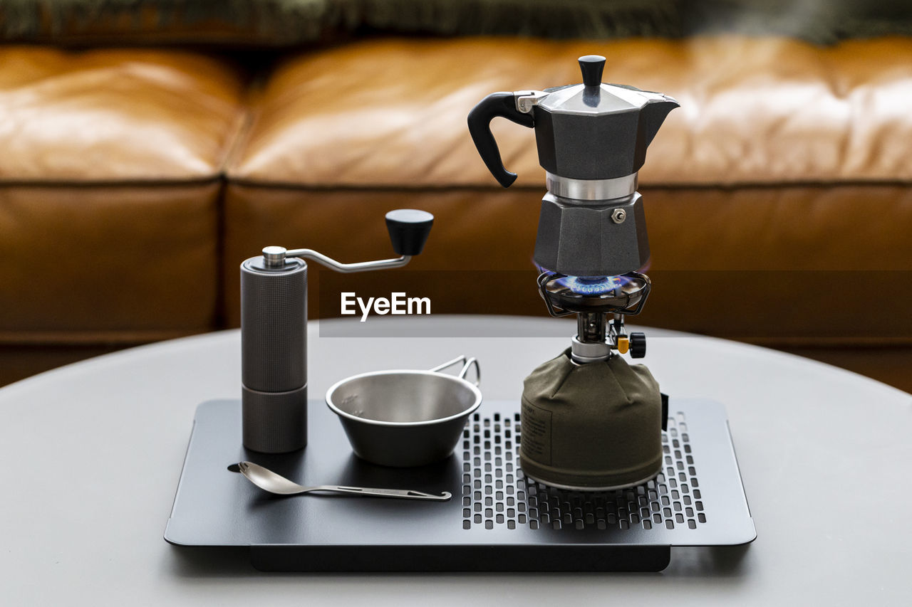 Close-up of coffee cup on table moka pot