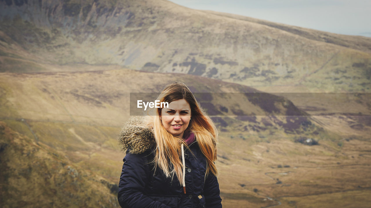 Portrait of young woman standing outdoors during winter