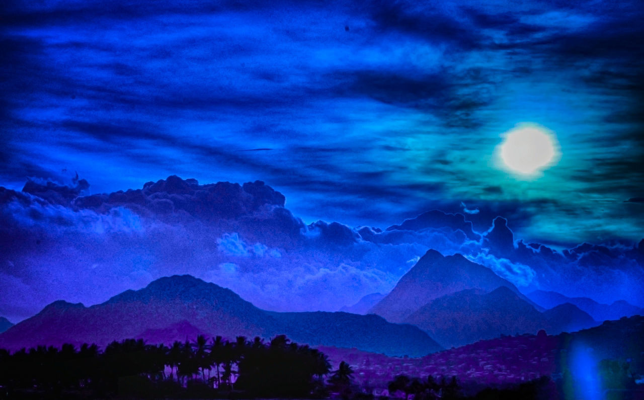 SCENIC VIEW OF MOUNTAINS AGAINST SKY AT NIGHT