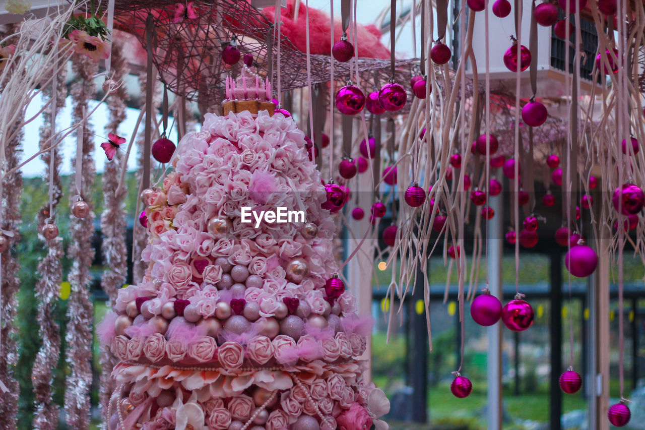 CLOSE-UP OF CHRISTMAS DECORATIONS HANGING ON STREET AT MARKET