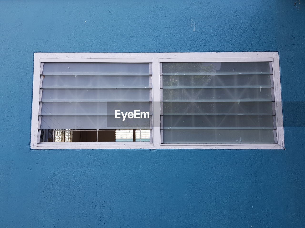 LOW ANGLE VIEW OF WINDOW ON BUILDING WALL