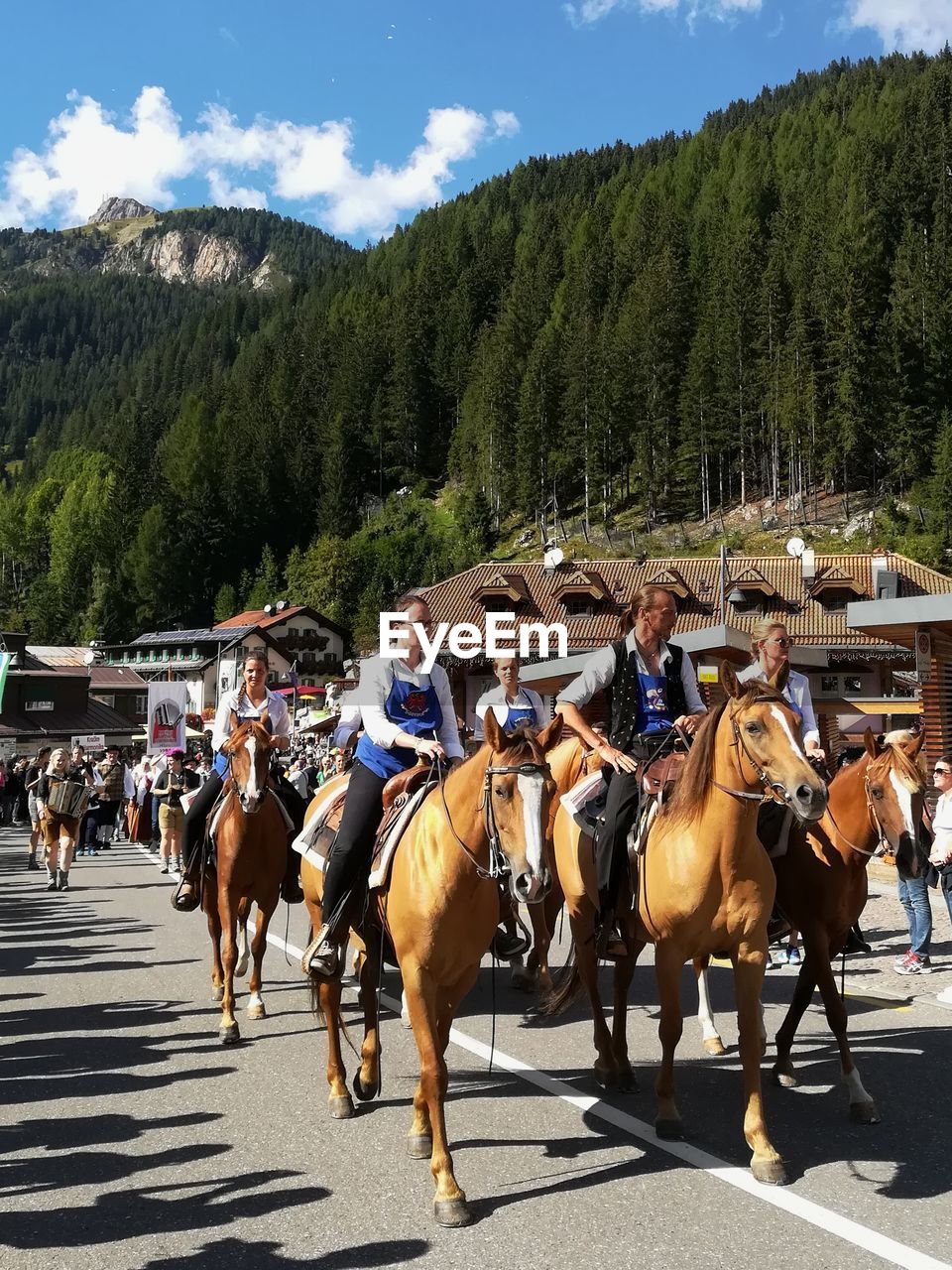 GROUP OF PEOPLE RIDING HORSE