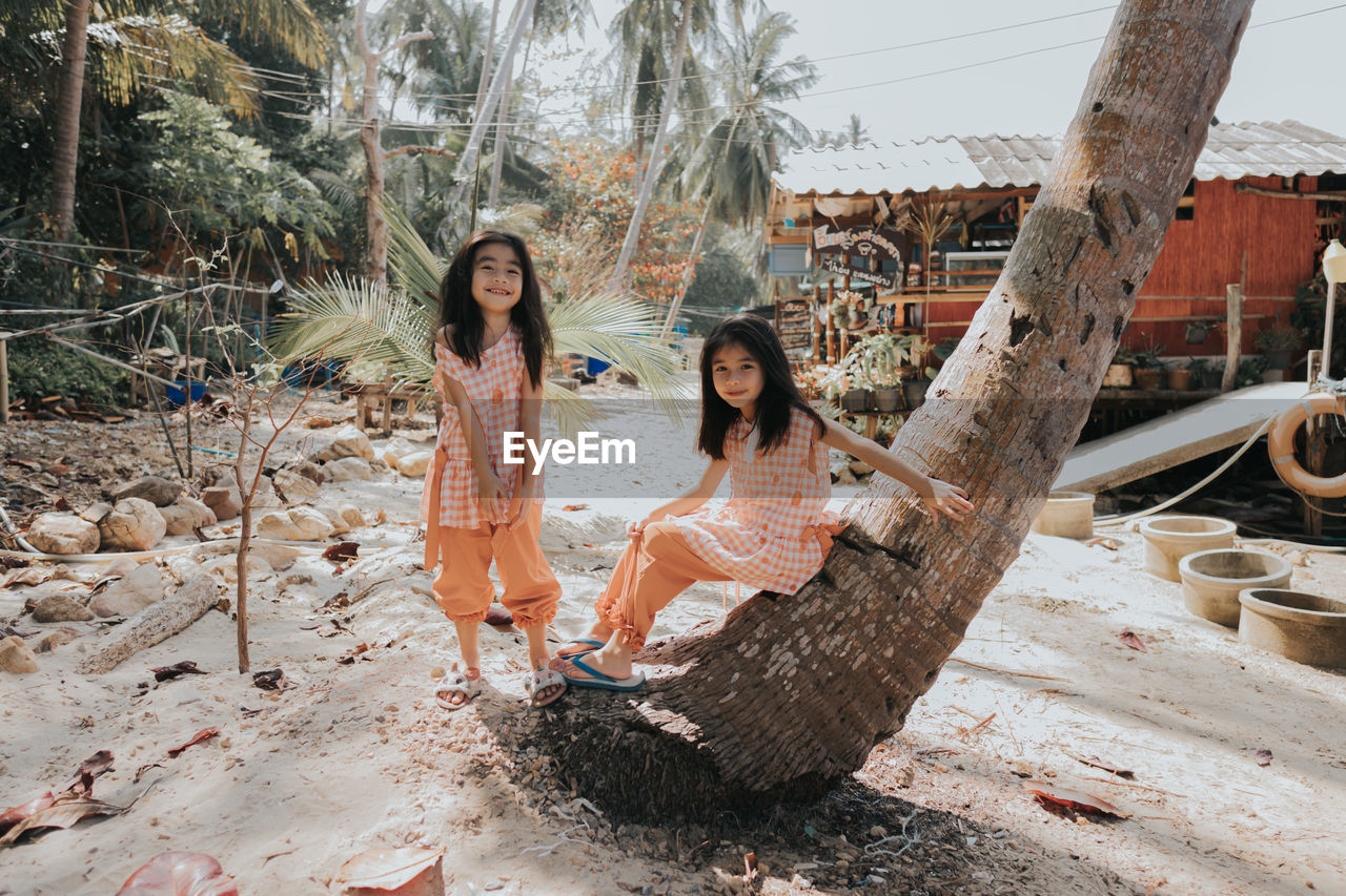 Women sitting on tree trunk