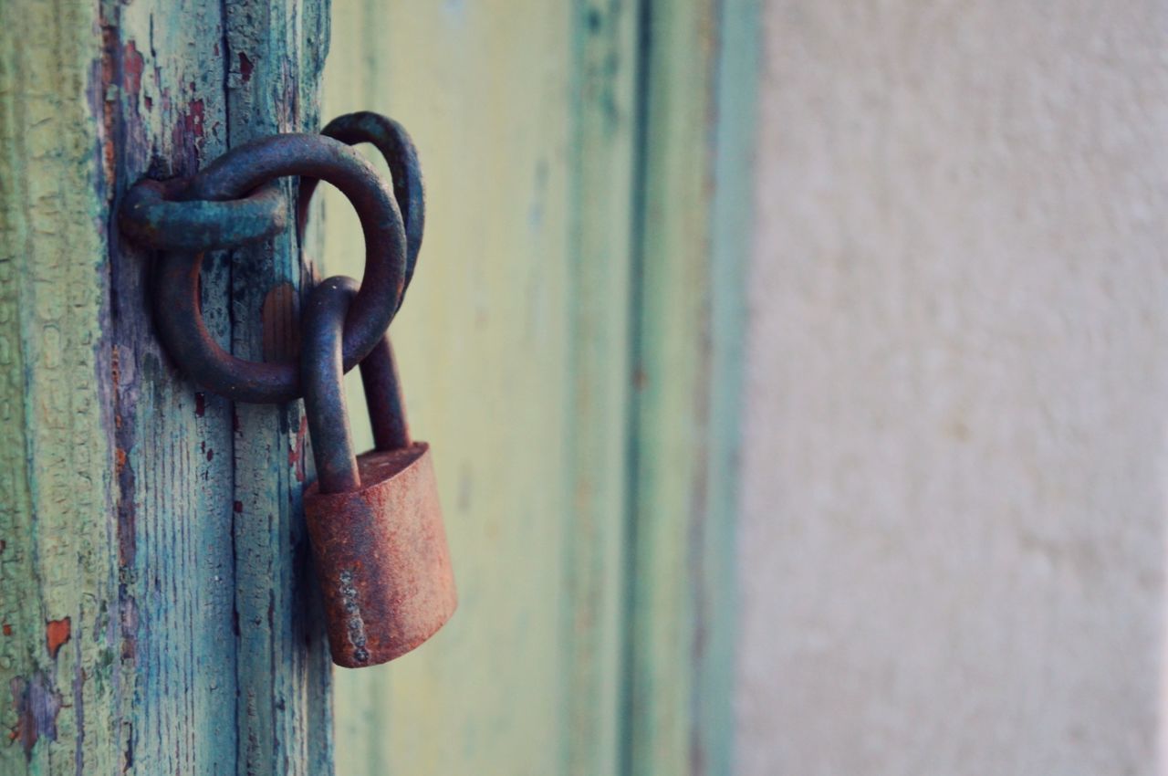 Close-up of rusty padlock on door